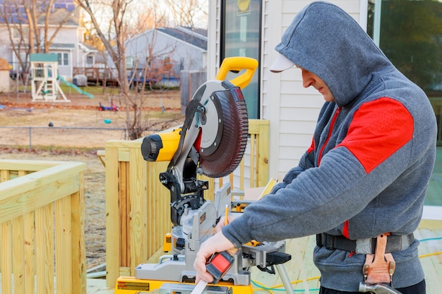 Circular saw cutting wooden plank. Blade with board close-up.