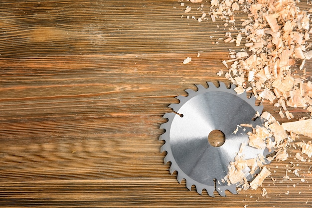 Circular saw disk on wooden . Professional carpenter's equipment