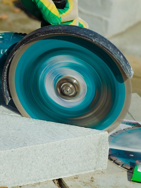 A circular saw is being used to grind concrete.