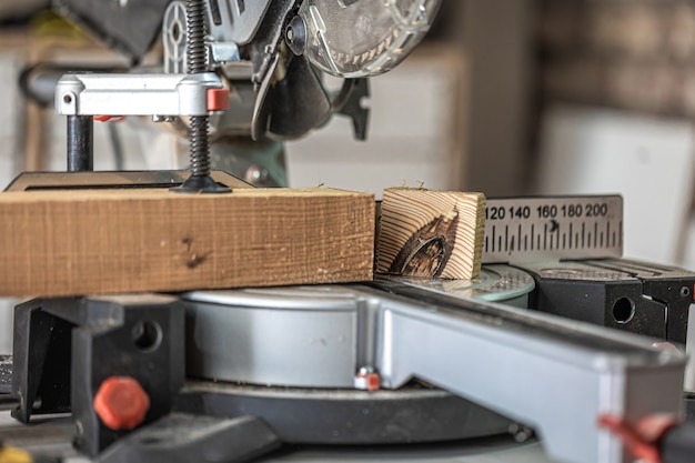 Photo circular saw miter saw photographed in the workshop atmosphere.