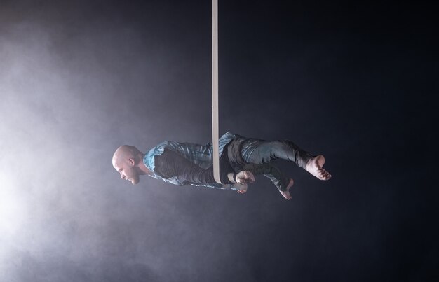 Circus artist on the aerial straps with costume