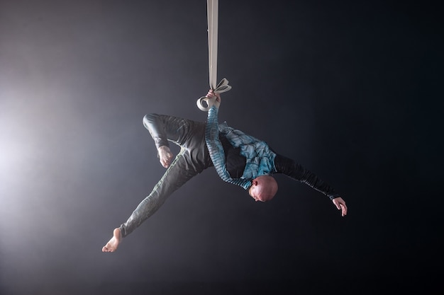 Circus artist on the aerial straps with costume