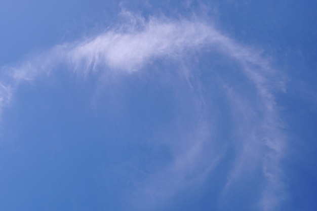 Cirrus fluffy clouds on light blue sky background.                                   