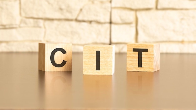 CIT text from wooden blocks on a gray stone background CIT is short for corporate income tax