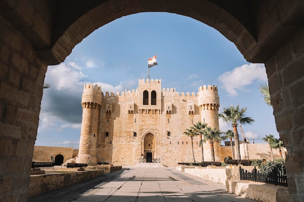 The Citadel of Qaitbay or the Fort of Qaitbay is a 15thcentury defensive fortress located on the Mediterranean sea coast Ordinary people walk nearby