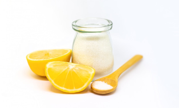 Citric acid in a glass jar and lemons