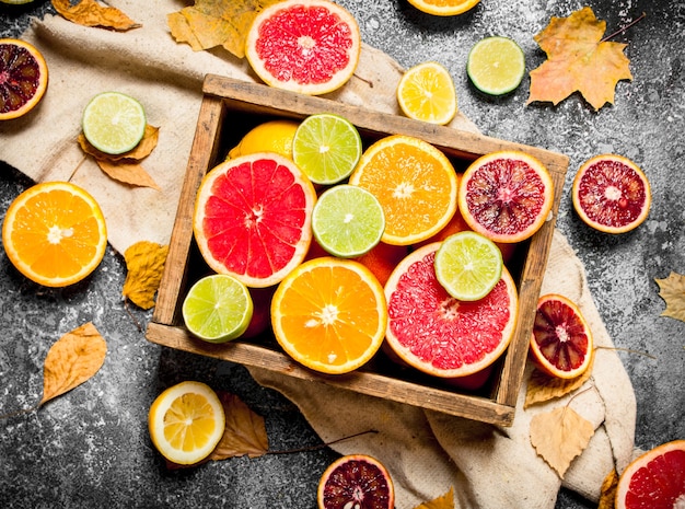 Citrus background. Fresh citrus fruit in an old box. On rustic background .