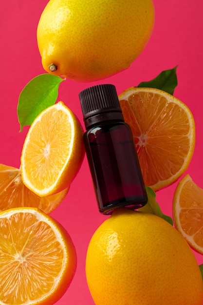 Citrus essential oil. Sliced citrus fruit and aroma bottles