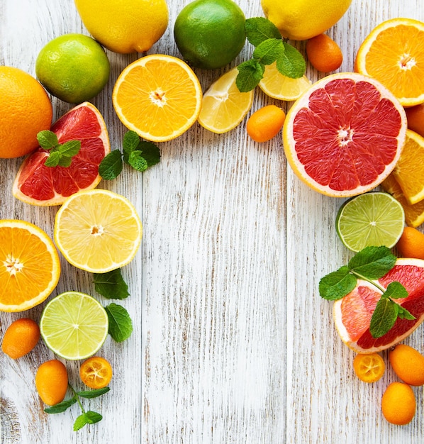 Citrus fresh fruits on a old wooden background