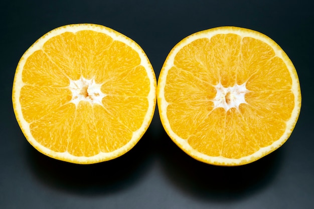 Citrus fruit sliced orange fruit on a dark background