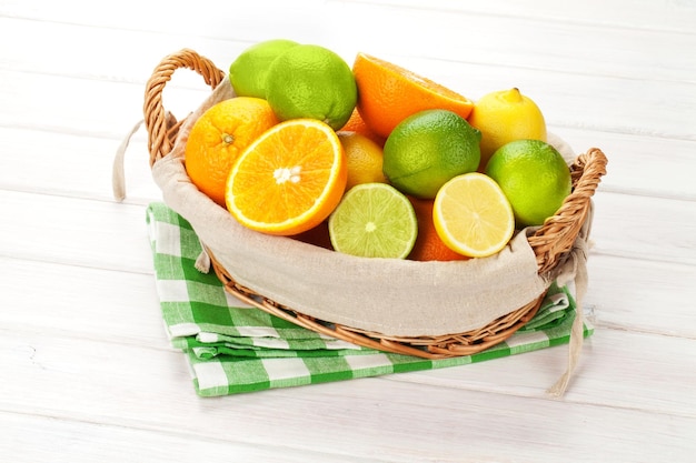 Citrus fruits in basket Oranges limes and lemons