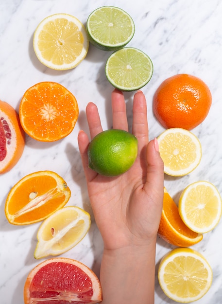 Foto agrumi. arancia, limone, pompelmo, mandarino e lime su uno sfondo di pietra alla moda