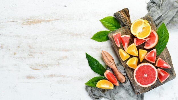 Citrus fruits on white wooden background Top view Free copy space