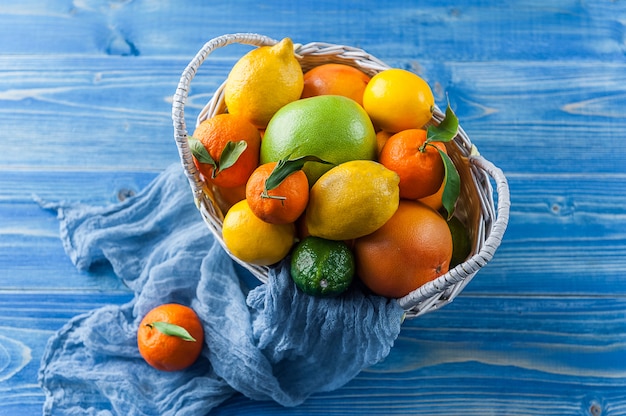 Citrus fruits in a wicker basket on a wooden table