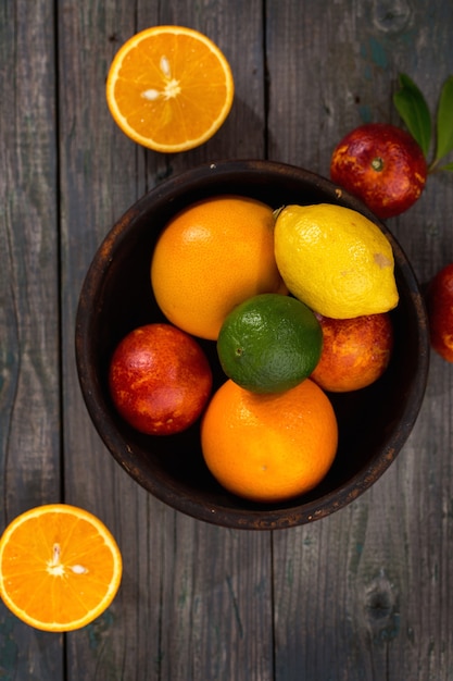 Citrus fruits in a wooden bowl on a table