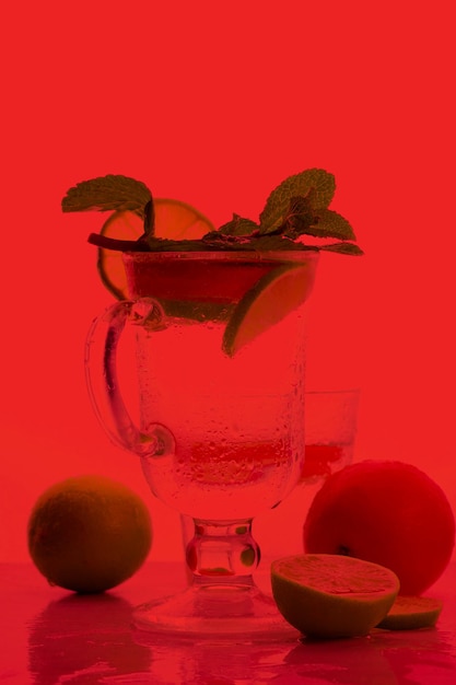citrus infused water non alcohol cocktails with orange lemon and lime on a colored background refreshing summer cocktails closeup