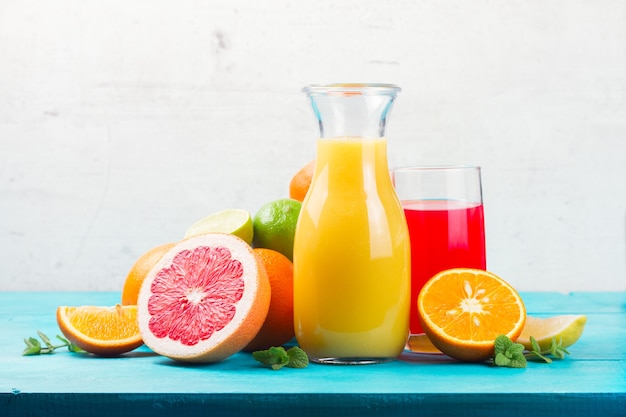 Citrus juices in jar and glass