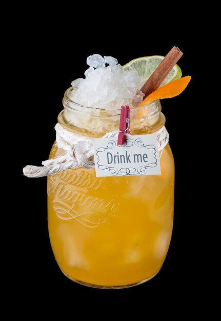 Citrus lemonade with honey in a glass jar on a dark background