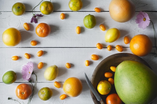 Photo citrus mix on the white wooden background