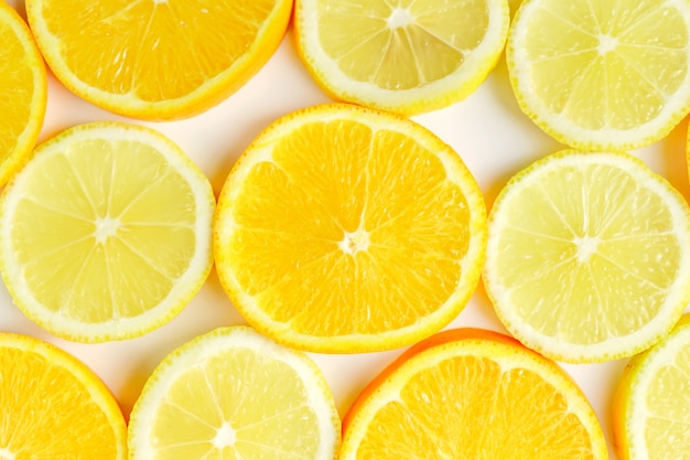 Citrus slice, oranges and lemons on white background. Fruits backdrop