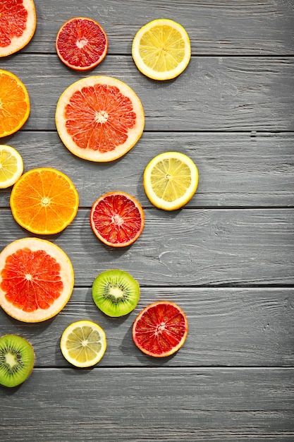 Citrus slices on wooden background