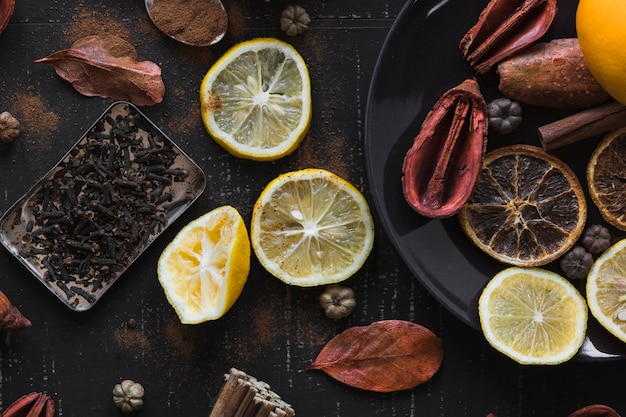 Citruses and spices on dark background