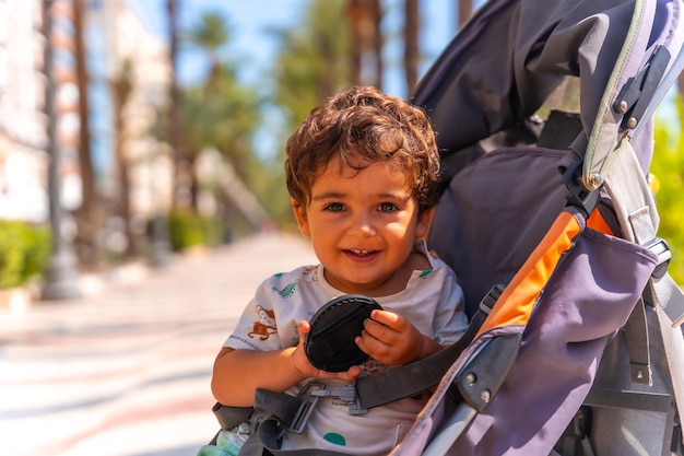 City of Alicante A boy in a car on the Las Olas walkway with beautiful palm trees on the coast