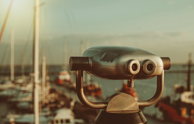 City binoculars on the background of the club yachts