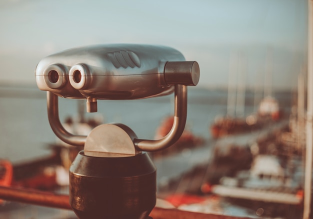 City binoculars on the background of the club yachts