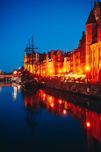 A city by the river with a lit up building in the background