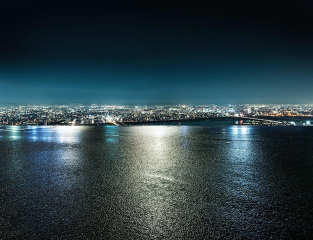 A city by the sea with a blue sky and lights background