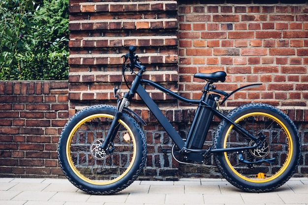 city electric bicycle near a brick wall. ecological urban transport