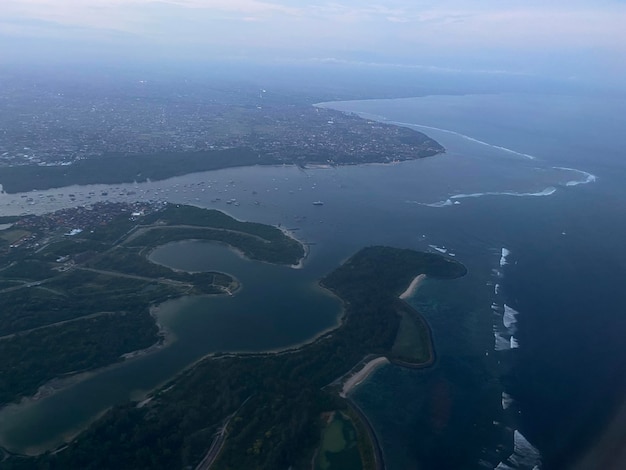 A city from a plane with the ocean in the background.