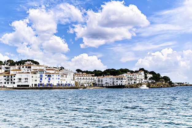 a city is surrounded by white buildings and the water is blue