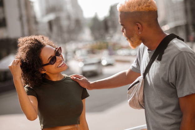 City life. A young man and a woman in the street enjoying the day