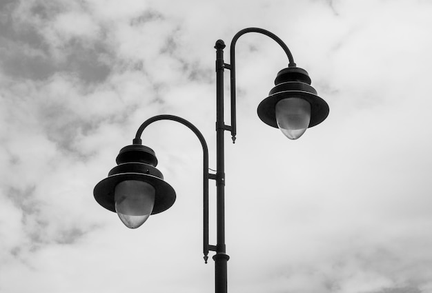 City lights during the day against the sky Turned off lights lamps in the city park