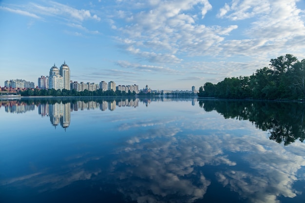 City on the river.Panoramic view of the city on the river and sky reflection on the water.