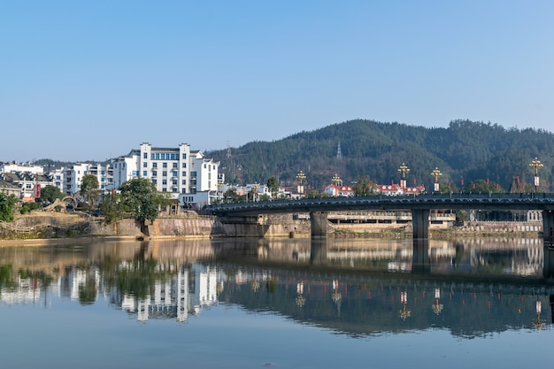 The city's buildings are reflected in the river