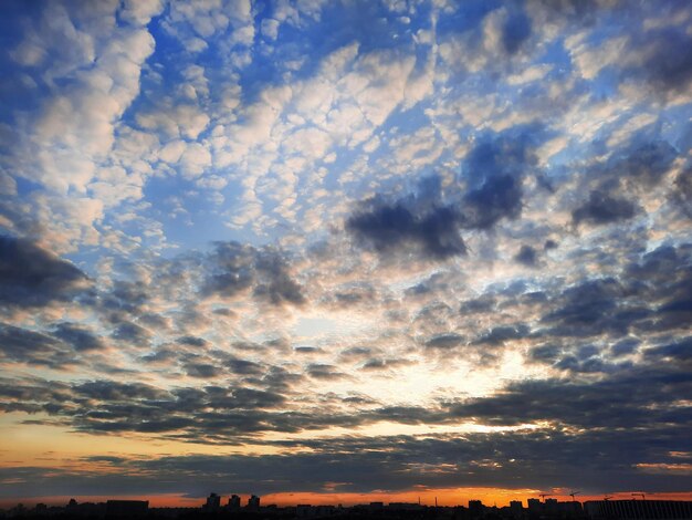 City silhouette against beautiful sunset cloudy sky scenery