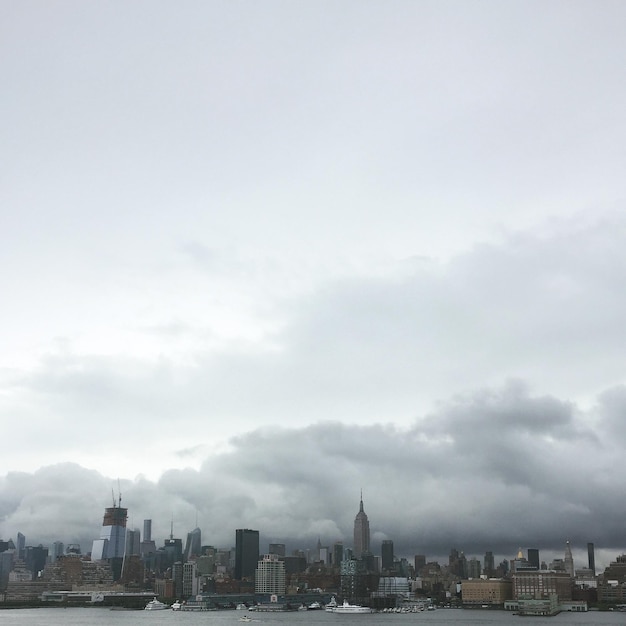 City skyline against cloudy sky