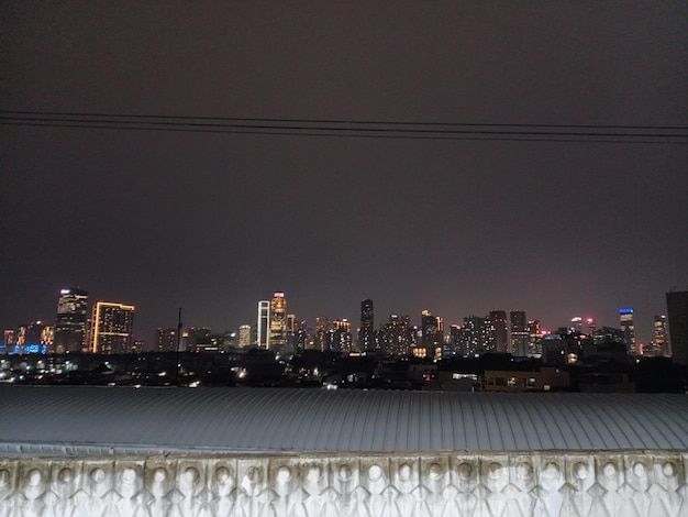 A city skyline with a dark night sky and a city skyline in the background.