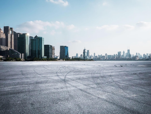 A city skyline with a lake and a parking lot.