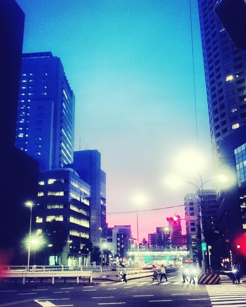 City street against blue sky at night