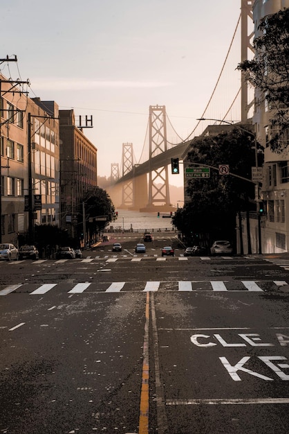 Photo city street and bridge in city against sky during sunset