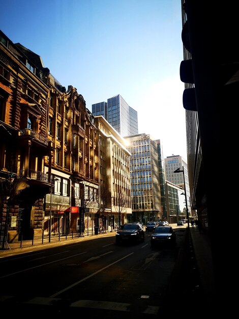 City street and buildings against clear sky