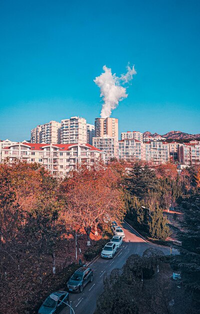 City street by buildings against blue sky