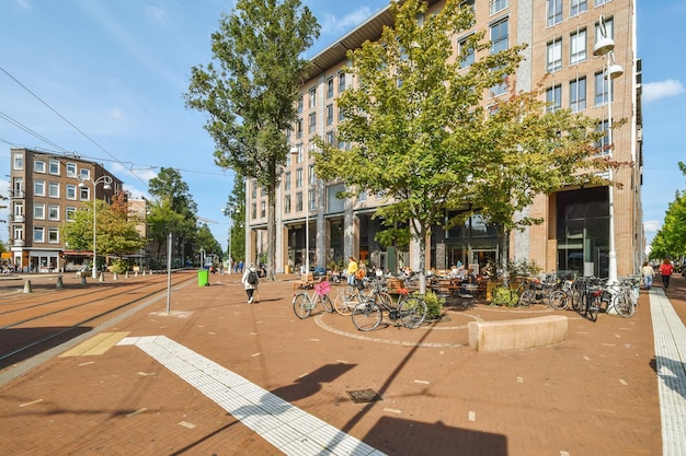 A city street with bikes parked outside a building