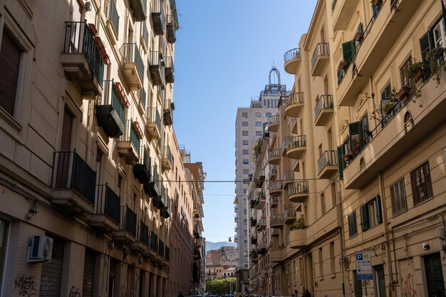 A city street with tall buildings and balconies