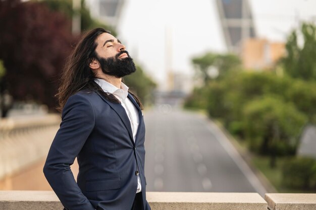 City tour business handsome man in suit has beard and long\
hair