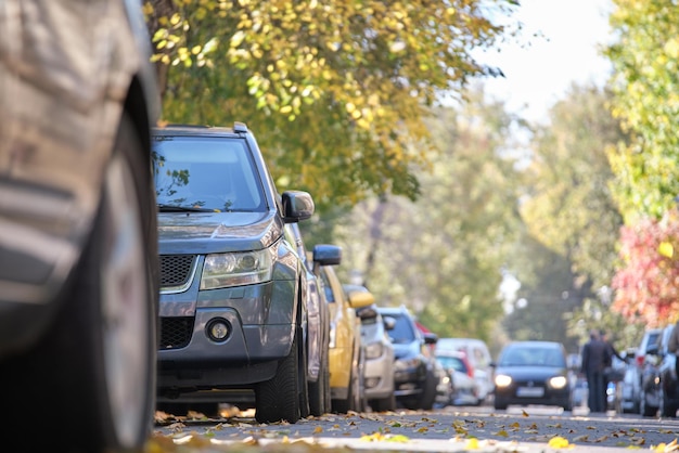 City traffic with many cars parked in line on street side